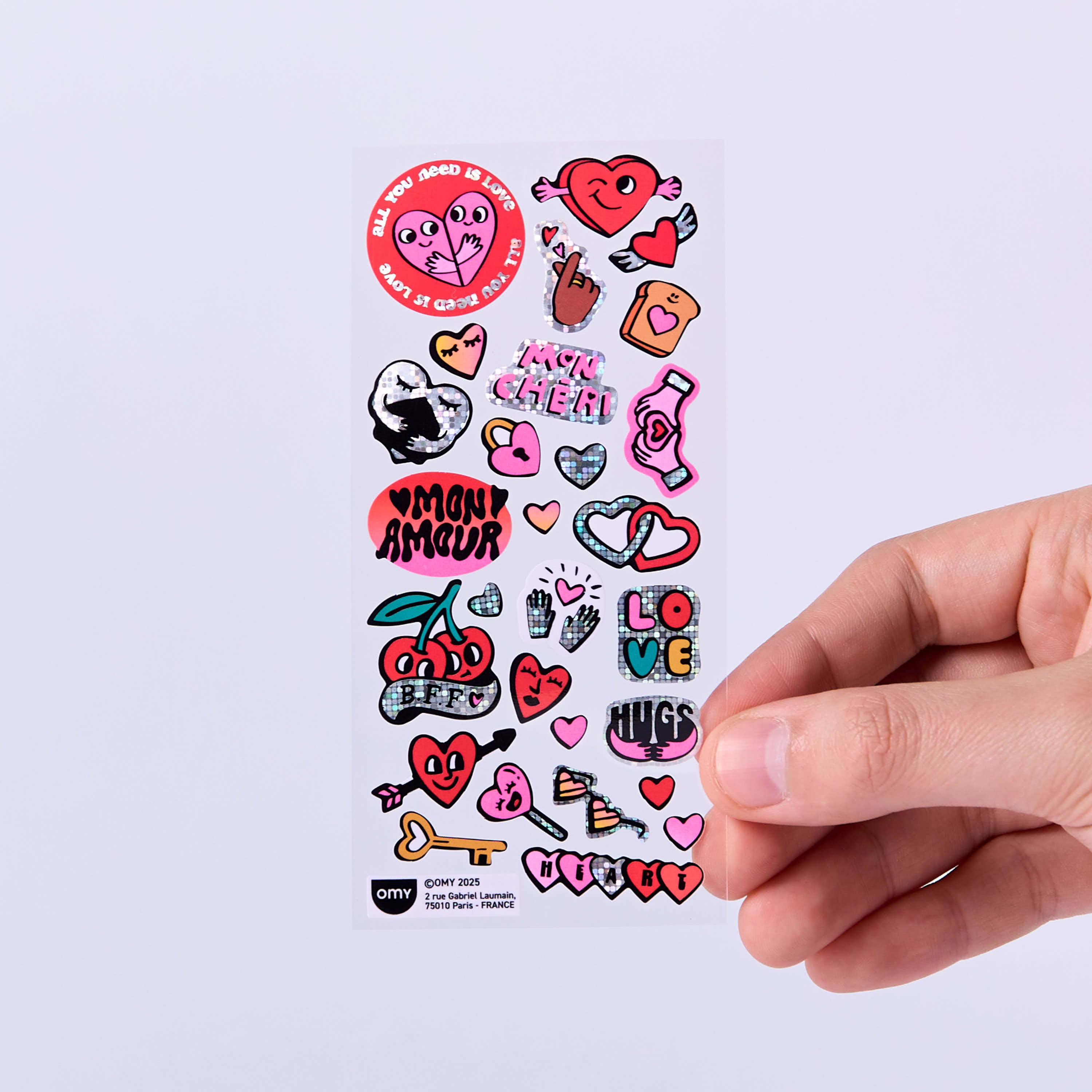 OMY Iconic Love — stickers applied on a friendship book and a card