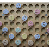 Petinka wooden letters, numbers and shapes arranged on the magnetic wall board