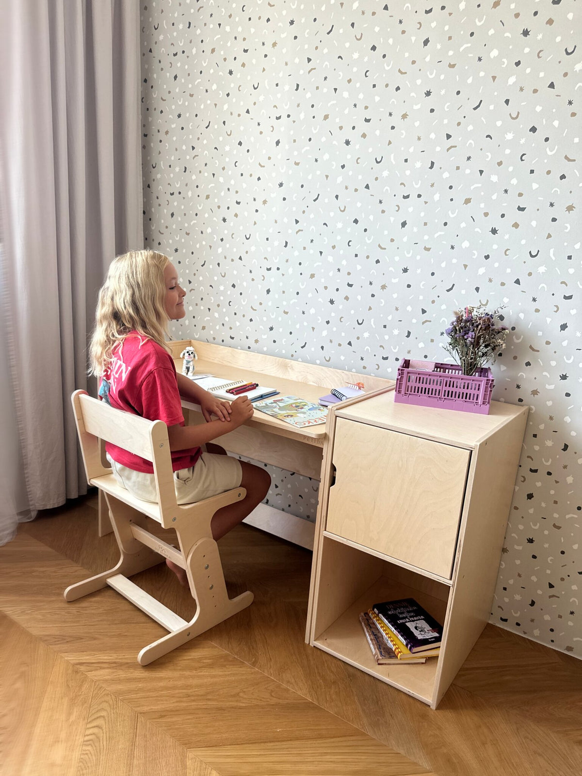 Child studying at the AGGIE desk with AGGIE chair and cabinet
