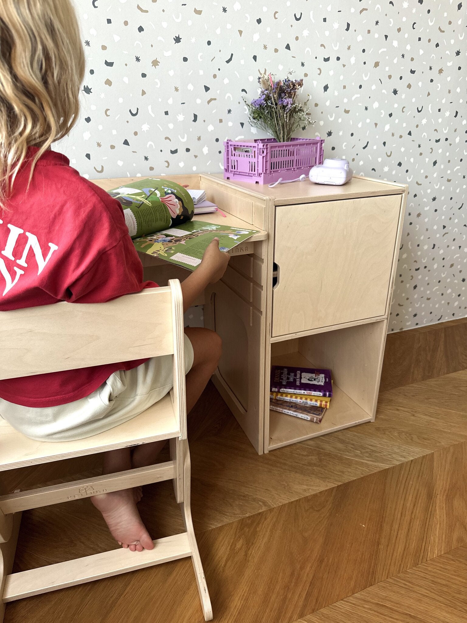Child sitting on the AGGIE growing chair at the AGGIE desk